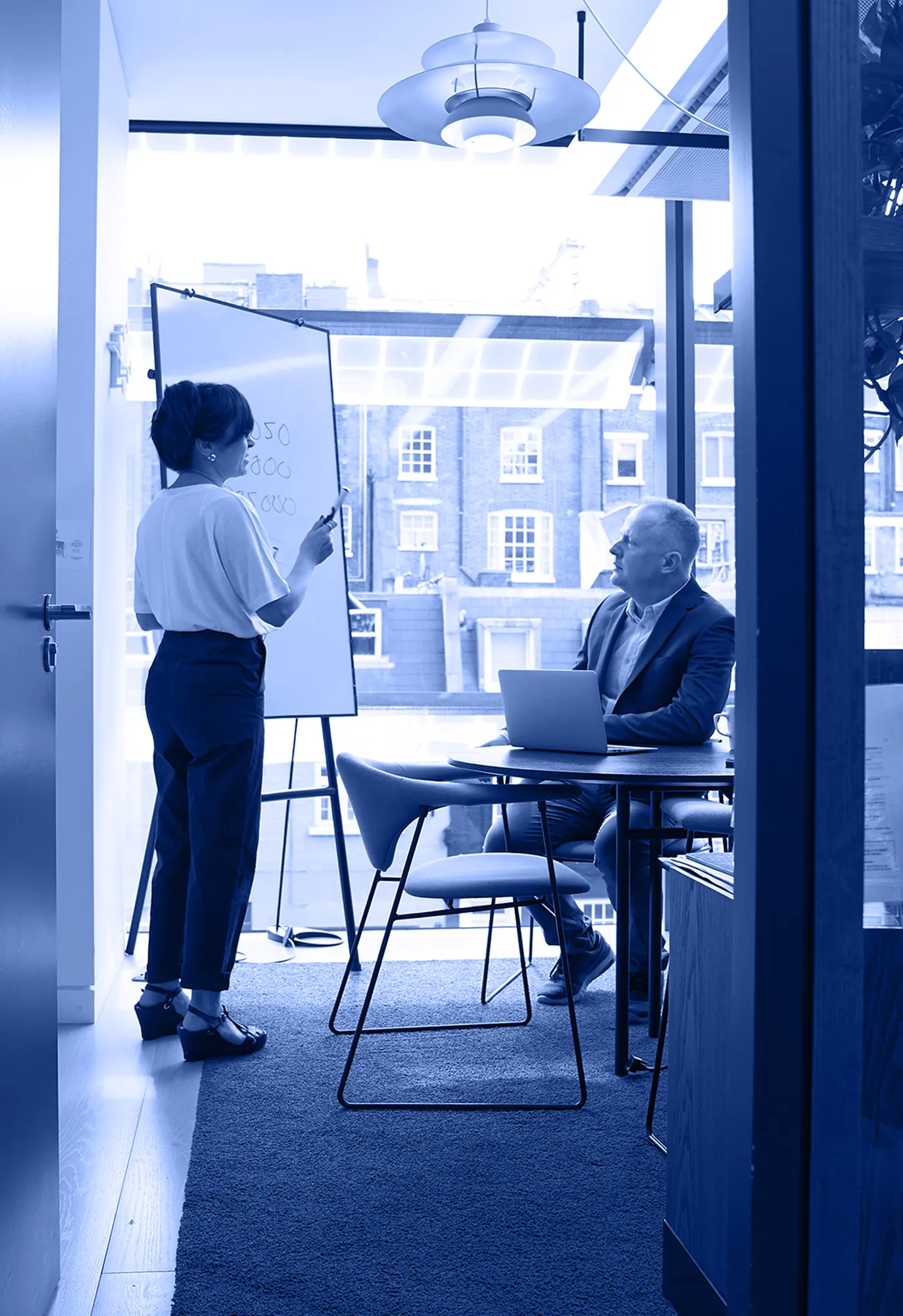Consultant presenting at a whiteboard